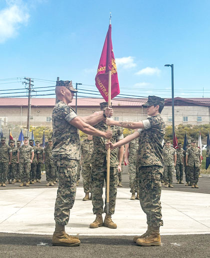 U.S. Marine Corps Maj. William J. Weyrauch, left, incoming company commander of 1st Communication Strategy and Operations Company, I Marine Expeditionary Force Information Group, holds the company guidon with Maj. Sarah D. Rhodes, outgoing company commander of 1st Communication Strategy and Operations Company, during a change of command ceremony at Marine Corps Base Camp Pendleton, California, May 16, 2025. The ceremonial passing of the guidon symbolizes the transfer of command from Rhodes to Weyrauch. Rhodes is a native of Florida, and Weyrauch is a native of Colorado. (U.S. Marine Corps photo by Staff Sgt. Hailey D. Clay)