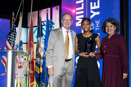 Ahsha B., center, receives the National Military Youth of the Year award in Washington, D.C., Aug. 4, 2022. The award recognizes military-connected youth, ages 14 to 18, for their commitment to community service, academic success, good character and citizenship, and establishing long-term goals. 